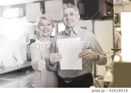 Mature couple are buying in store on credit 42618018