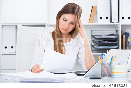 Worried young female in office Worried young female in office 42618081