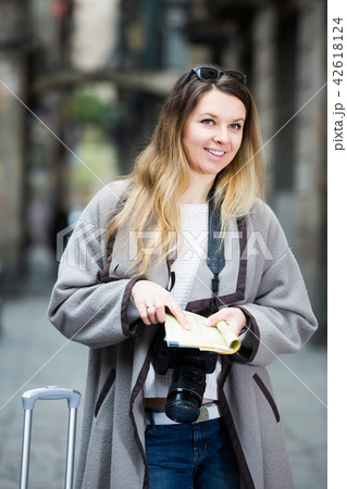 Blond ordinary girl holding brochure in hands 42618124