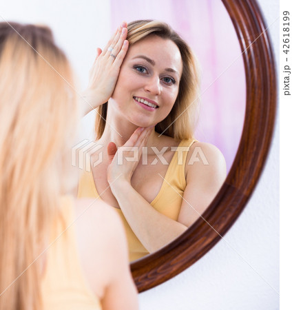 woman looking at mirror woman looking at mirror 42618199