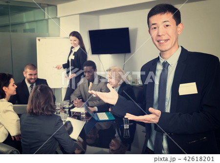Successful business group with smiling Korean man foreground in meeting room 42618201
