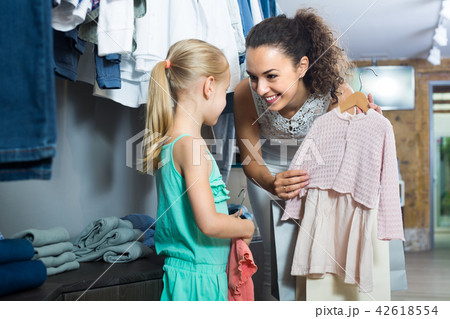 young woman and girl in clothes store. 42618554