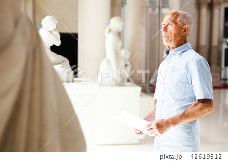 Man with guide at sculptures exposition Man with guide at sculptures exposition 42619312