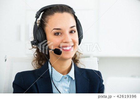 girl with headset and laptop in office. girl with headset and laptop in office. 42619396