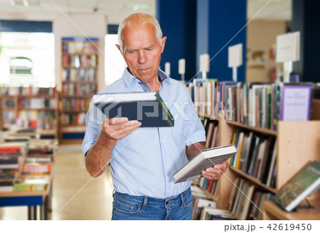 man holding two books and offering to somebody 42619450