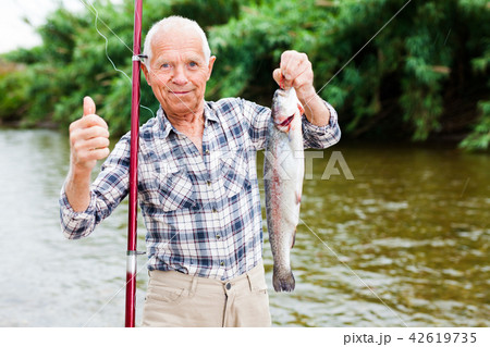 Fisherman holding fresh catch fish Fisherman holding fresh catch fish 42619735