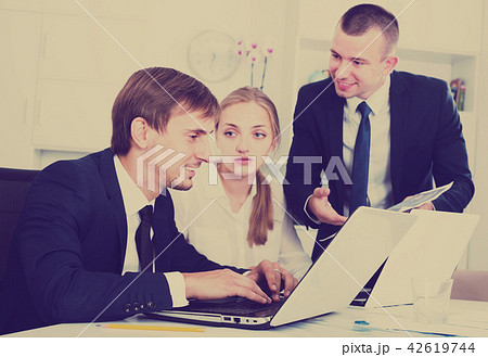 Three concerned coworkers different sexes working in company off 42619744