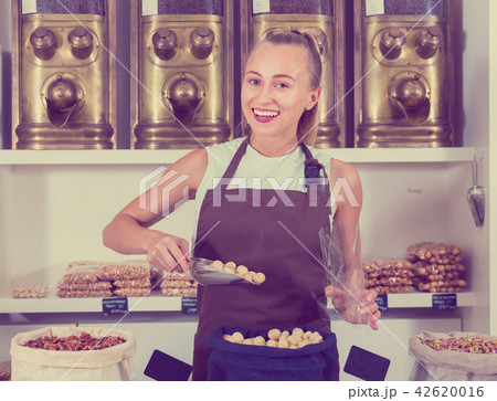 Young woman is offering nuts 42620016