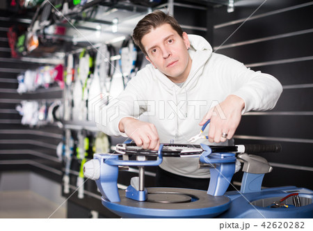 male is repairing rockets for tennis male is repairing rockets for tennis 42620282