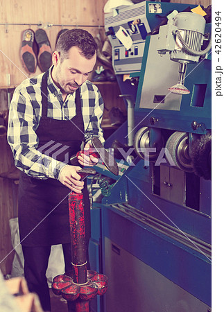 Male worker repairing shoe Male worker repairing shoe 42620494