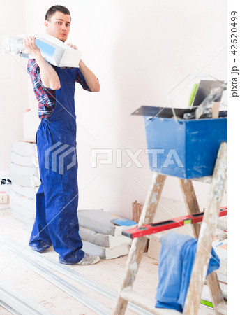 Worker is going to mix putty 42620499