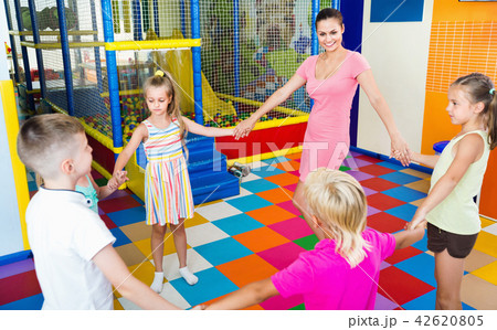 Kids dancing with teacher in school class Kids dancing with teacher in school class 42620805