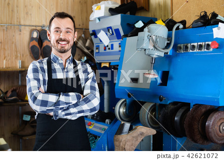 Male worker demonstrating workplace and tools in shoe 42621072