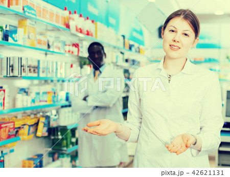 female pharmacist inviting to drugstore female pharmacist inviting to drugstore 42621131