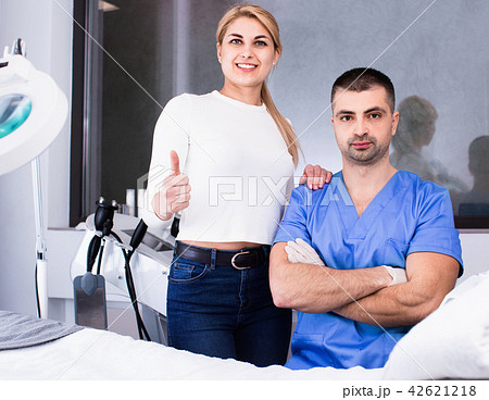 Portrait of professional beautician and female client satisfied with results of cosmetic procedures Portrait of professional beautician and female client satisfied with results of cosmetic procedures 42621218