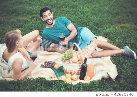 Couple are talking and drinking wine in time picnic outdoor Couple are talking and drinking wine in time picnic outdoor 42621546