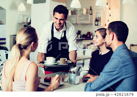 Waiter is bringing drinking and delicious desserts Waiter is bringing drinking and delicious desserts 42621679