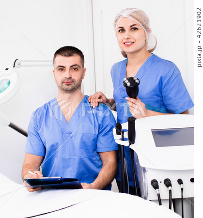 Portrait of two professional cosmeticians in modern medical esthetic office 42621902