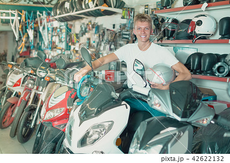 Man sitting on the motorbike with helmet in the hand 42622132