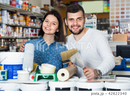 Couple purchasing tools for house improvements in paint supplies store Couple purchasing tools for house improvements in paint supplies store 42622340