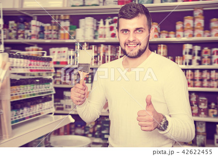 Glad man choosing new brush for decoration Glad man choosing new brush for decoration 42622455