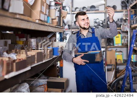 worker checking small details for sanitary engineering in workshop 42622494