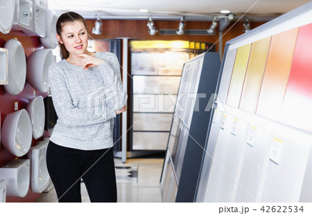Young female choosing kitchen ceramic tile in modern shop 42622534
