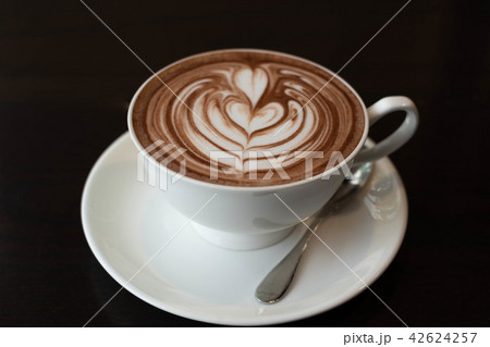 Hot coffee in white cup with saucer With milk foam Hot coffee in white cup with saucer With milk foam 42624257