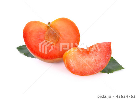half and sliced fresh pluot on white background 42624763
