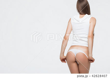 Woman with perfect body removing underwear - Stock Photo [42628407] - PIXTA