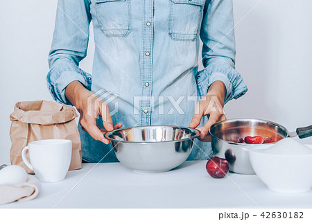 Young woman wearing blue shirt holding 42630182