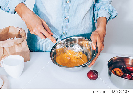 Female's hands whisk eggs with sugar 42630183