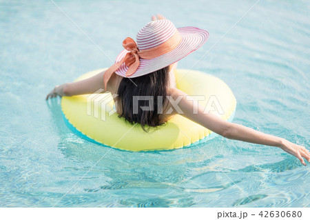 Woman in bikini on lime green air inflatable ring. 42630680