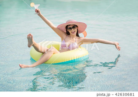 Woman in bikini on lime green air inflatable ring. 42630681