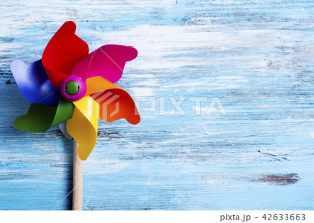 colorful pinwheel on a blue wooden surface 42633663