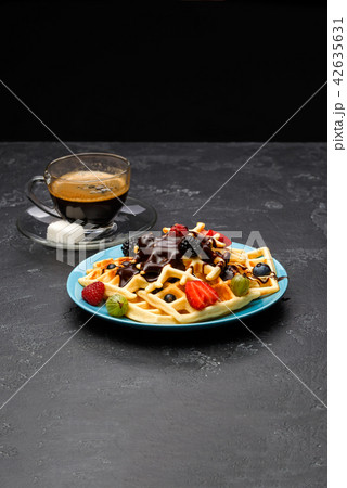 Photo of cup of coffee with Belgian wafers with strawberries, raspberries 42635631