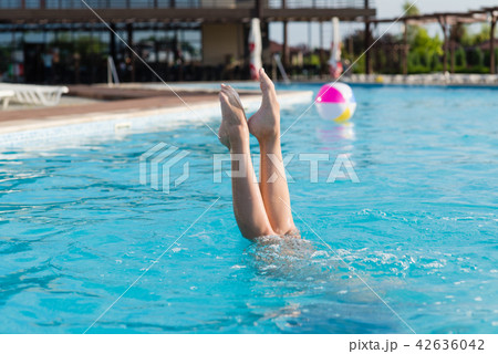 Beautiful female legs stick out of water Beautiful female legs stick out of water 42636042