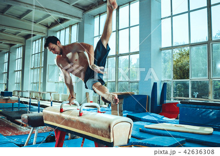 The sportsman during difficult exercise, sports gymnastics The sportsman during difficult exercise, sports gymnastics 42636308