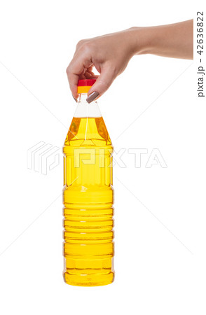 bottle with vegetable oil in hand bottle with vegetable oil in hand 42636822