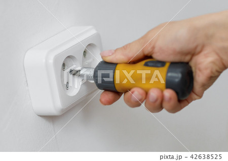 electrician installing electrical socket 42638525