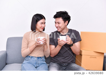 Moving house Concept. Asian young man is carrying his belongings 42639080