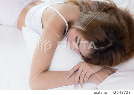 young beautiful woman sleeping on bed 42645728