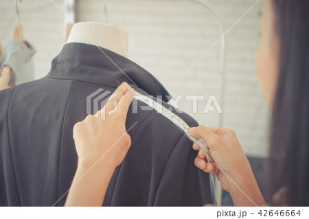 Fashion Designer measuring shoulder with tape Fashion Designer measuring shoulder with tape 42646664