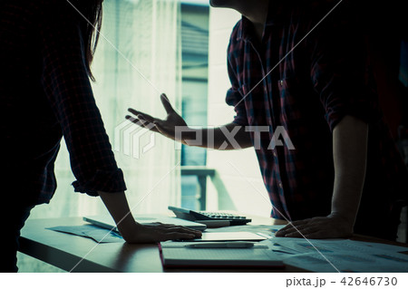 Co worker is argueing with friend over office table 42646730