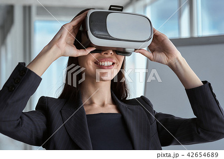 Businessperson at office alone standing wearing virtual reality 42654689