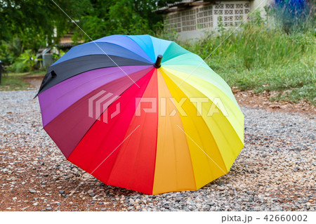 Colourful umbrella on stone floor 42660002