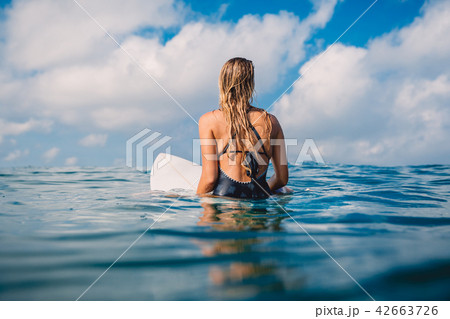 Surfer woman in swimwear with surfboard. Surfer woman in swimwear with surfboard. 42663726
