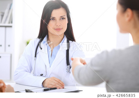 Doctor and patient shaking hands to each other. Healthcare, medicine and trusting concept Doctor and patient shaking hands to each other. Healthcare, medicine and trusting concept 42665835