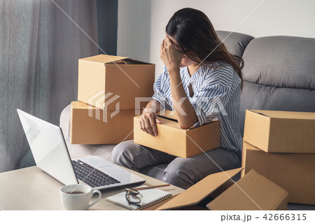 Stressed business woman holding head in hand Stressed business woman holding head in hand 42666315