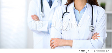 Groupe of unknown doctors standing straight in hospital office. Close Up of stethoscope at 42666612